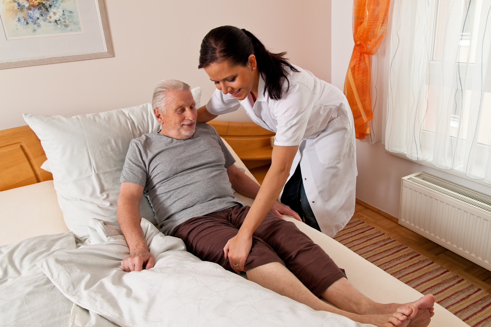 Home Care Giver Caring For An Elderly Patient
